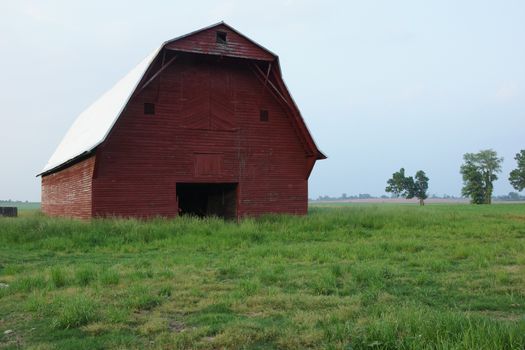 A red barn near a farm out in the country