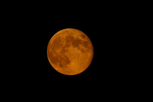 An orange harvest moon as seen in full