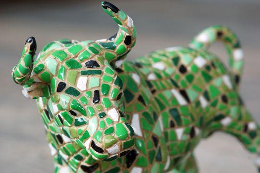A small toy mosaic standing bull statue