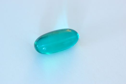 A single blue gel capsule containing medicine