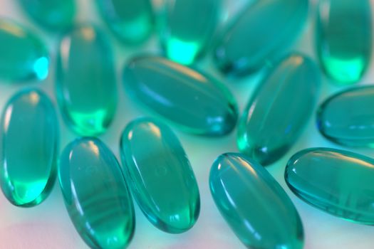Multiple blue gel capsules containing medicine