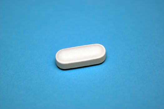 A white tablet containing prescription medicine