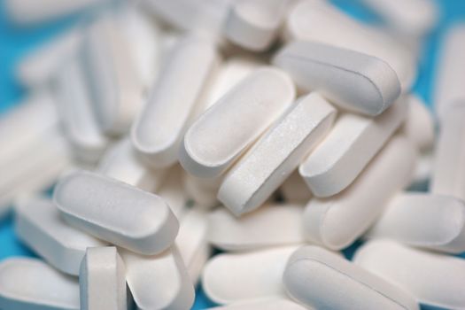 Multiple white tablets containing prescription medicine