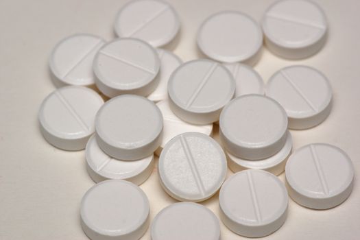A group of white round circulare tablets containing medicine