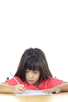 Cute little girl is writing using a pen in preschool