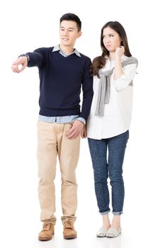 Young attractive Asian couple of happy husband and unhappy wife, full length portrait isolated on white.