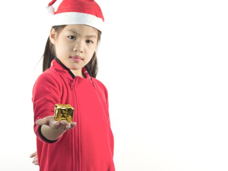 Little girl in the santa claus hat, holding a gift box in hand