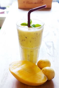 Healthy Smoothie juice, mix Mango with passion fruit on wood background 
