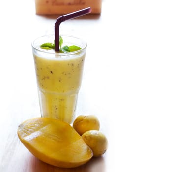 Healthy Smoothie juice, mix Mango with passion fruit on wood background