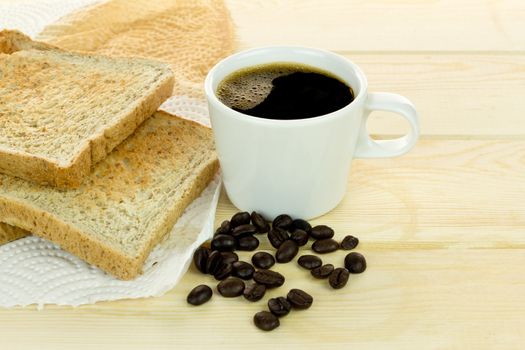 Delicious breakfast with fresh hot coffee, and whole grain bread. on wood background