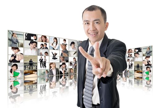 Asian business man or boss standing in front of tV screen wall showing pictures of business concept.