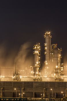 Night scene of Water vapor from cooling tower in chemical plant