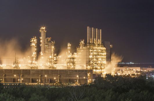 Night scene of Water vapor from cooling tower in chemical plant