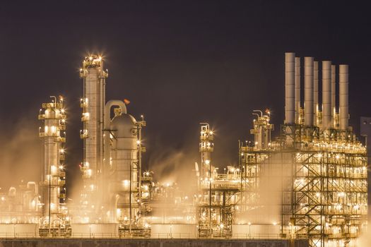 Night scene of Water vapor from cooling tower in chemical plant
