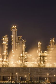 Night scene of Water vapor from cooling tower in chemical plant
