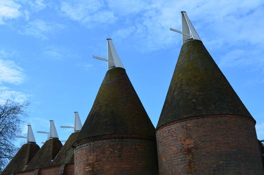 Hop drying buildings called Oast Houses in the County of Kent,England. These were used For drying hops before the beer process can begin.