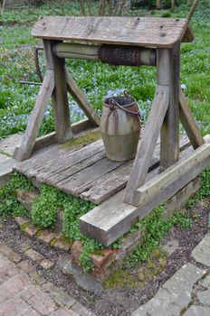 A rustic garden water well in a cottage garden in England.