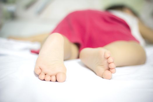 baby sleeping in bed focus on feet