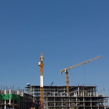 The building crane over blue sky 