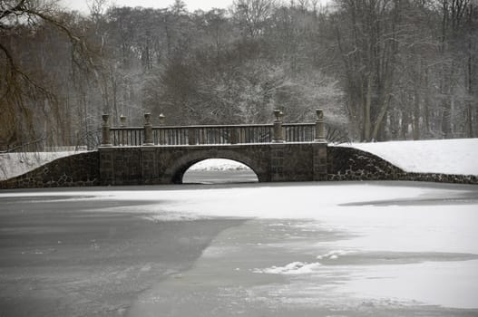 Bridge over frozen lake at winter time