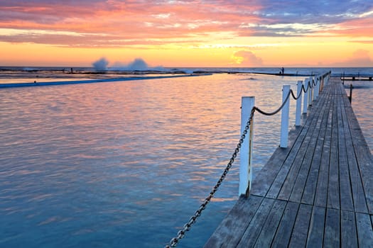 The view across Narrabeen Ocean Rock Pools and the rock shelf beyond on a spectacular sunrise morning.   The waters beckons you, 