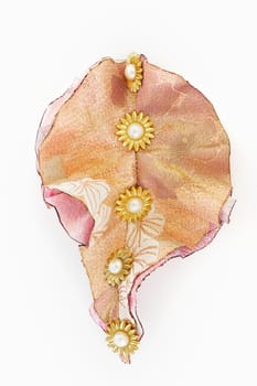 Brooch with beads and silk ribbons on white background