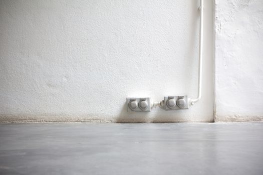 Vintage Old dirty electrical outlets on the white wall