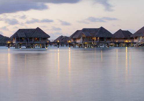 image of  over water bungalows with light at dusk in bora bora