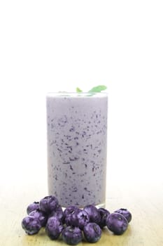 fresh blueberry smoothie with blueberries on wood