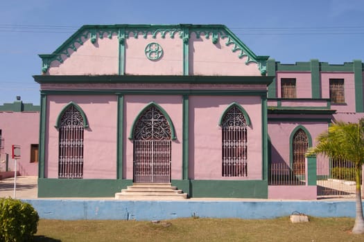 Colorful pink and green public building in Matanzas, Cuba showing some of the city's architecture