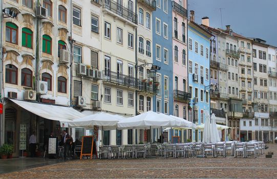 COIMBRA,PORTUGAL,MARCH 25,2013: Popular touristic square with restaurants and shops called Praca do Comercio, in Coimbra,Portugal, March 25, 2013