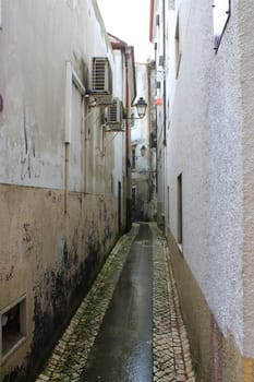 Narrow street, walkway, or alleyway in old Coimbra, Portugal