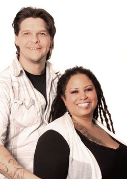 Beautiful couple with ethnic curvaceous woman with long dreadlocks, and both with tattoos and piercings, on a white background