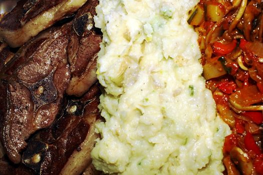 Delicious plate with pork chops, mashed potatoes and a vegetable stew