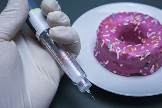 Insulin injecting pen, next to a cake, concept of diabetes
