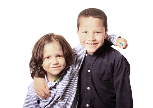 High key portrait of two young little brothers or friends arm in arm on a white background