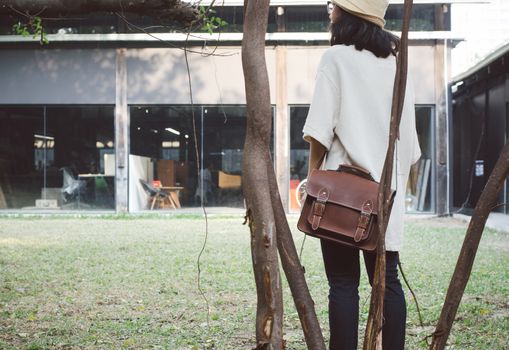 Fashion woman with vintage leather bag, retro filter