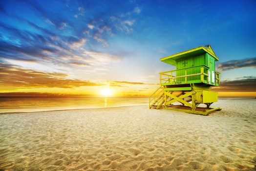 Miami South Beach sunrise with lifeguard tower and coastline with colorful cloud and blue sky. 