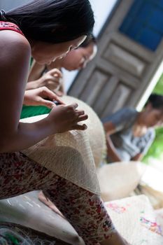 QUY NHON, VIET NAM- JUNE 16: People working indoor, they making conical hat, Quy Nhon, June 16,2012