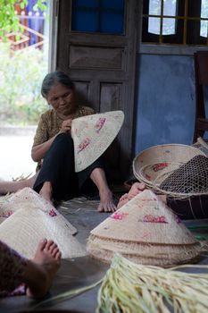 QUY NHON, VIET NAM- JUNE 16: People working indoor, they making conical hat, Quy Nhon, June 16,2012