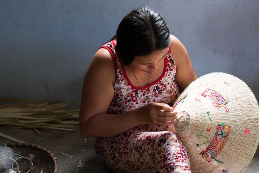 QUY NHON, VIET NAM- JUNE 16: People working indoor, they making conical hat, Quy Nhon, June 16,2012