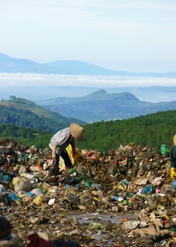 DA LAT, VIET NAM-SEPTEMBER 5: People earn they live by pick up trash at large garbage ground in Da Lat, Viet Nam on September 5, 2013