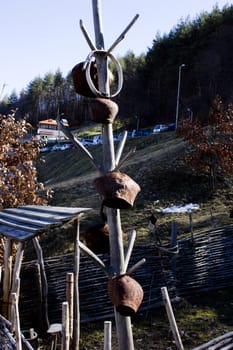 Cow bells hung from a wooden pole. Picture taken in a old village yard.