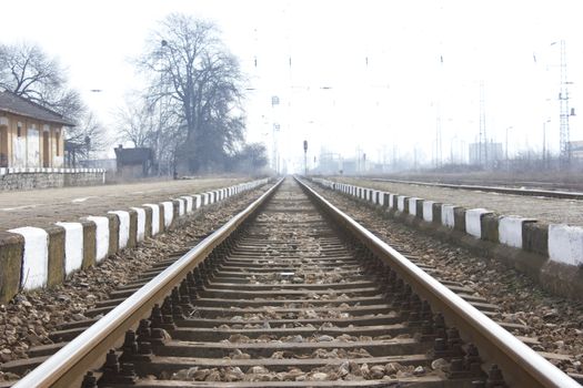 Railroad metal train tracks shot at perspective view.