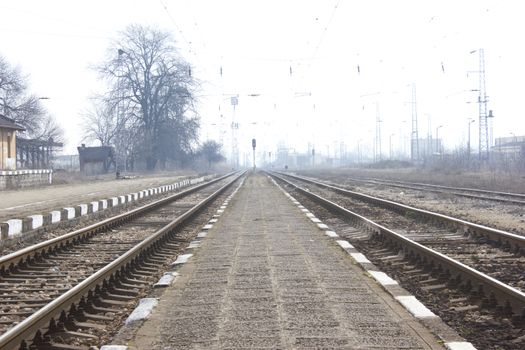 Railroad metal train tracks shot at perspective view.