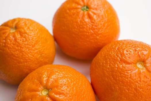 Vibrant mandarin fruit on a white background.