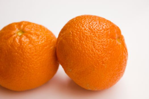 Vibrant mandarin fruit on a white background.