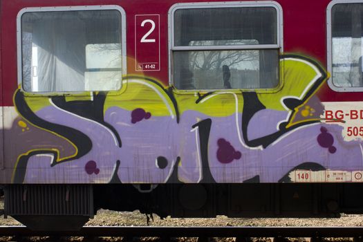 Train with graffity art sprayed on the side of it.