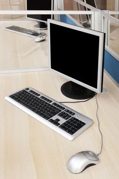 computers behind the glass in a modern office