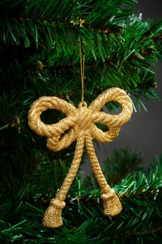 gold ornament on the artificial Christmas tree